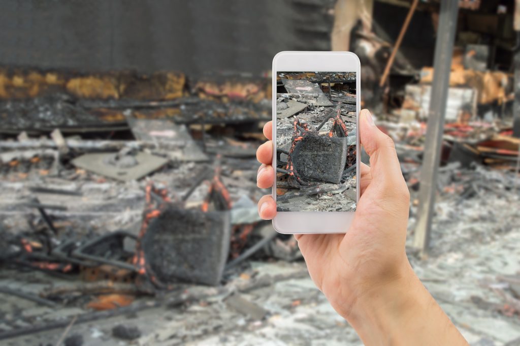 Camera showing photo of fire damage after house fire