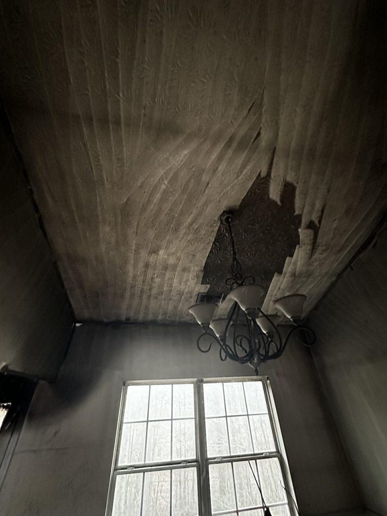 A ceiling with fire damage from a grease fire.