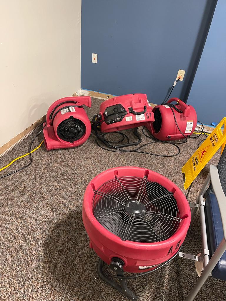 Our red air movers set up inside a Boca Raton office building after a roof rain pipe failure