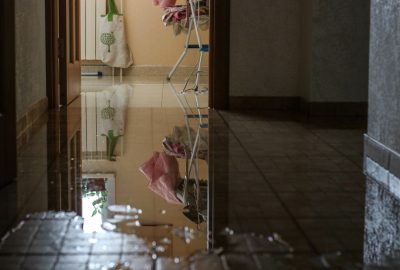 standing water on a hallway floor causing water damage