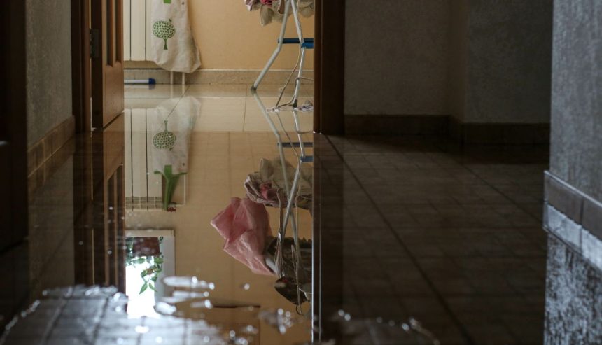 standing water on a hallway floor causing water damage