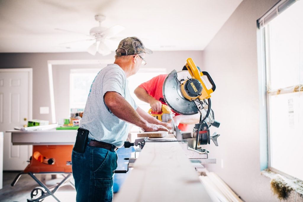 Man standing infront miter saw