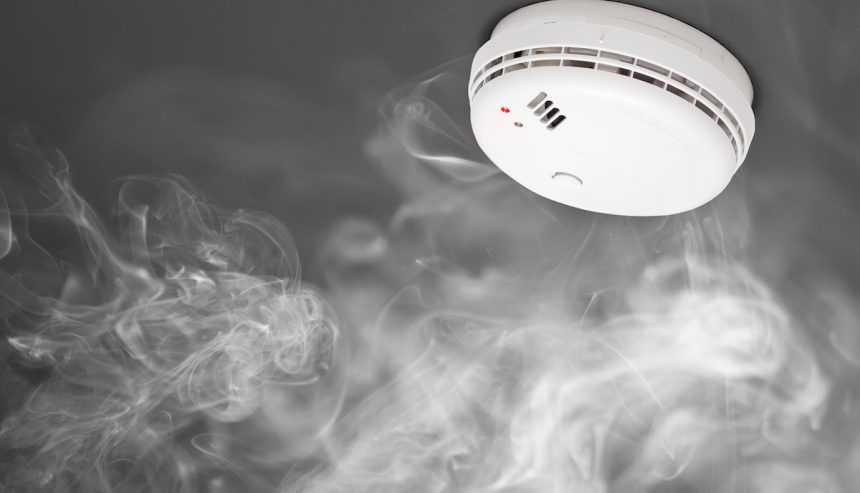 Smoke surrounding smoke detector. Understanding the different smoke detector types can protect your home.