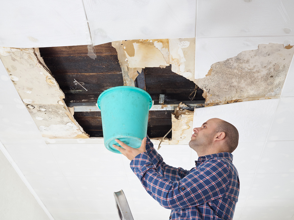 Man dealing with a leaky roof