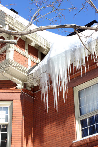 Ice dams are one of the telltale signs of water damage once it builds up from the gutters and onto the roof.