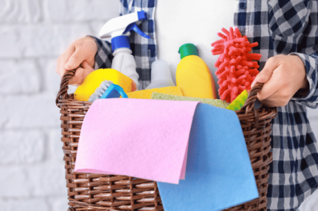 woman holding basket of household chemicals