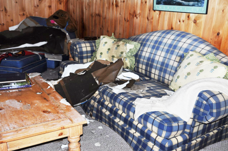 room with water-logged sofa after a flood