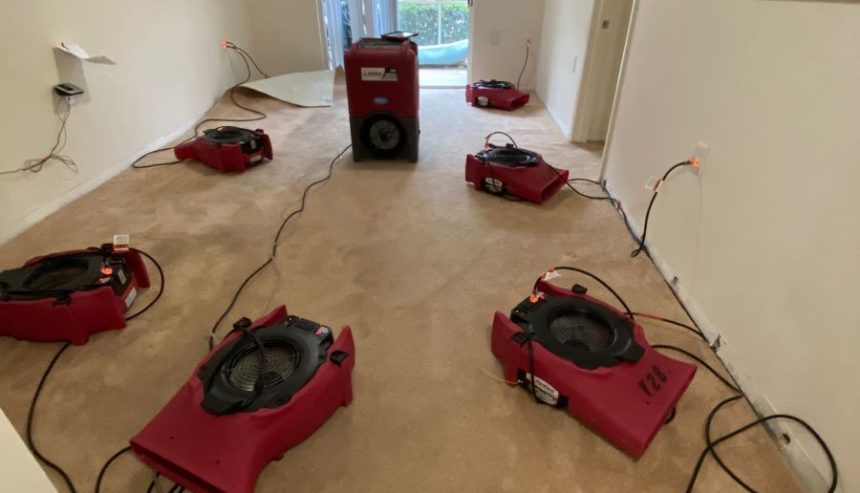 Air movers set up to dry areas affected by broken toilet supply line