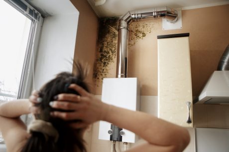 a woman finding mold while she's cleaning