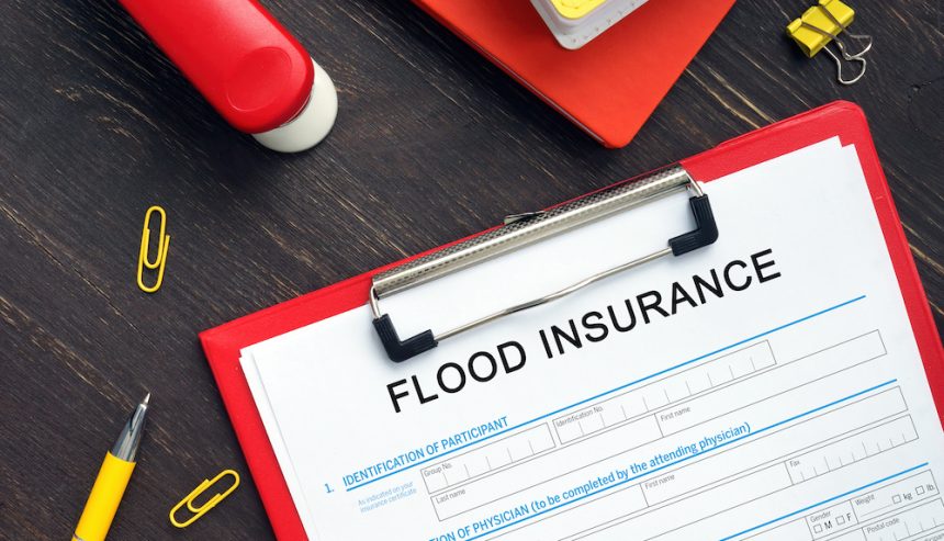 A clipboard with a flood insurance policy on it