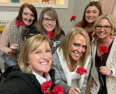 Insurance Solutions From Amber insurance office posing with their flowers from Jessica in our Valentine's Day Give Back!