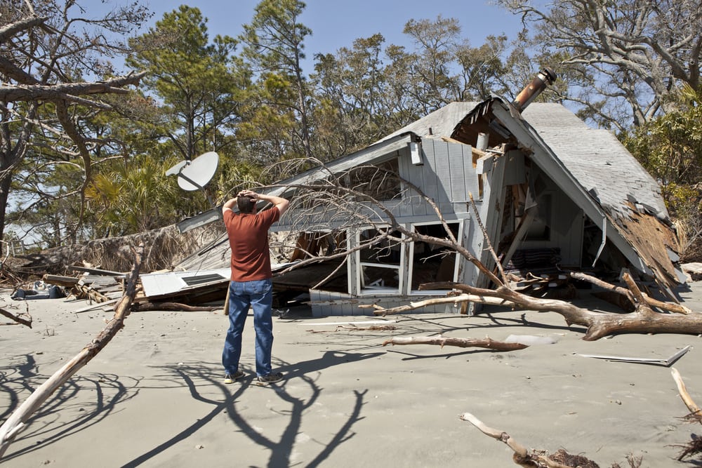 PuroClean.com - man outside his home after a hurricane destroys his home