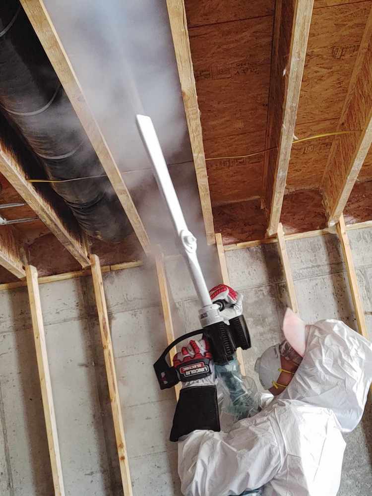 A technician conducts dry-ice blasting on a fire damaged home