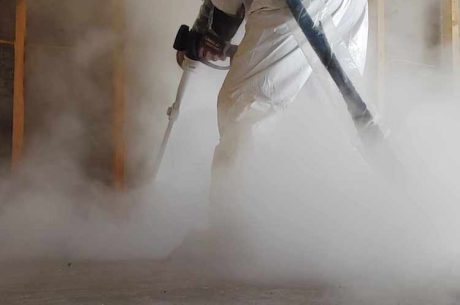 A technician conducts dry-ice blasting on a fire damaged home