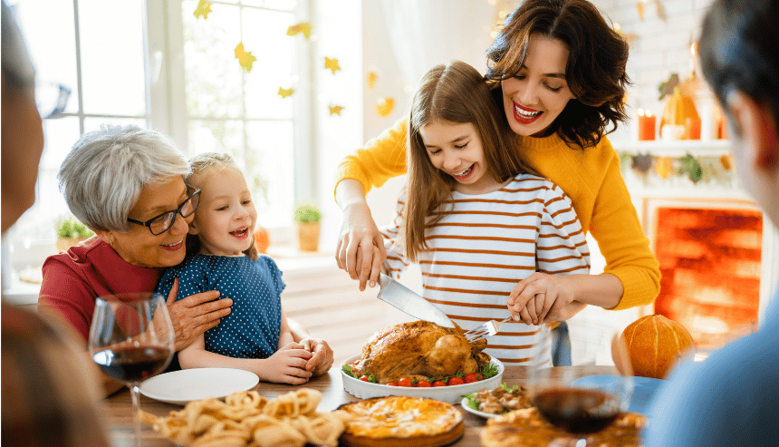 family carving turkey with kids