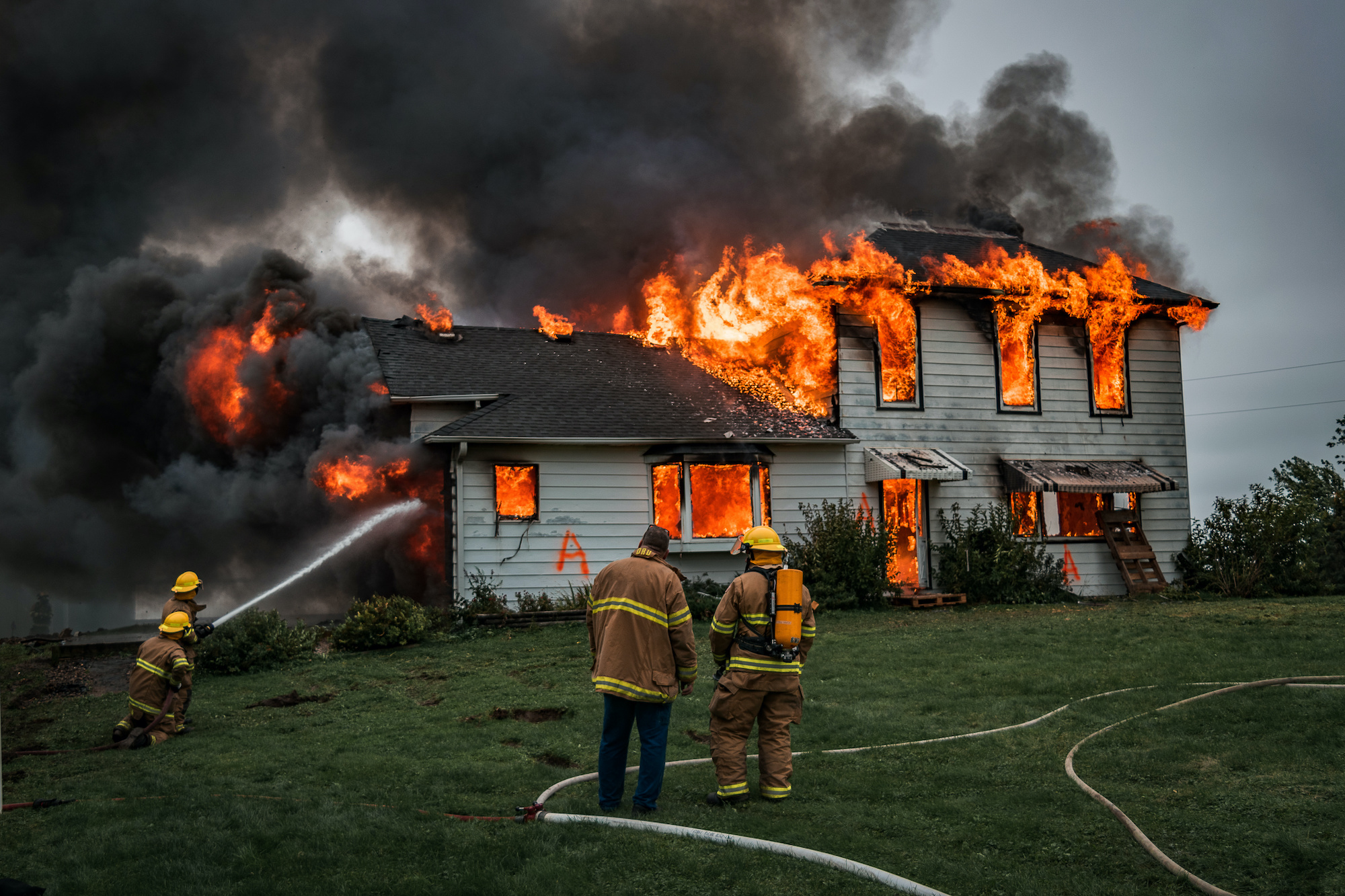 Fire Fighters Putting Out A House Fire