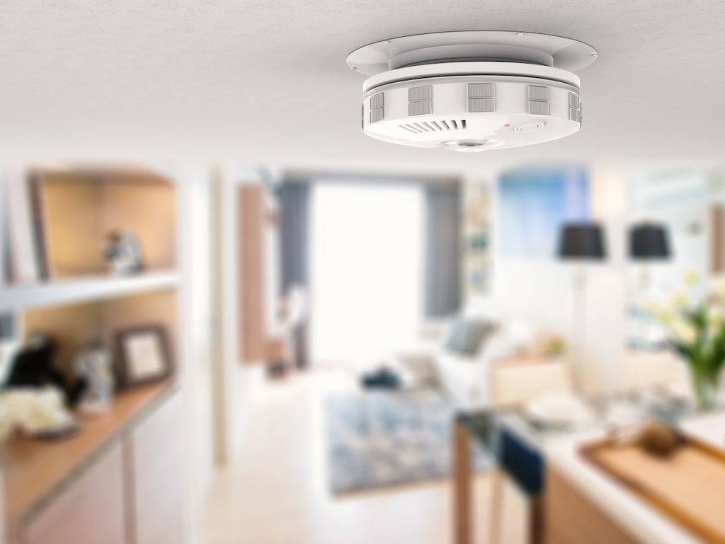 Smoke detector on ceiling. Choosing the best of the smoke detector types can protect your home and family.