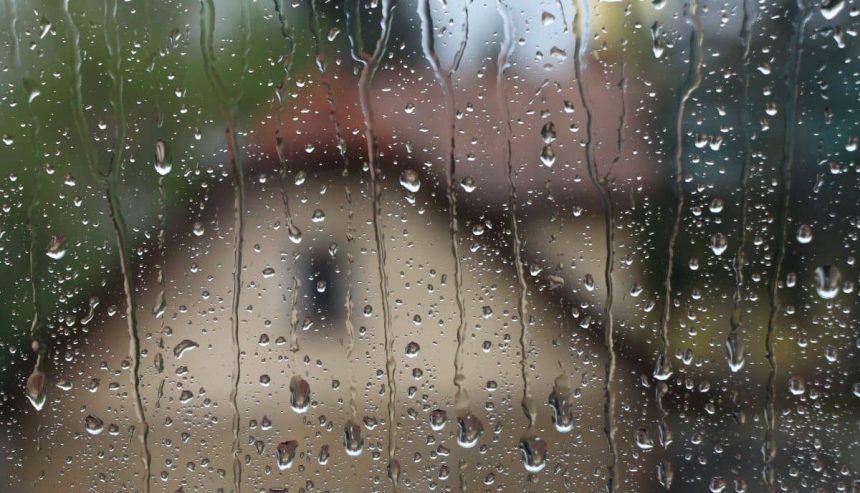 Looking out window at rain dripping down. Spring storm preparedness is key this time of year.