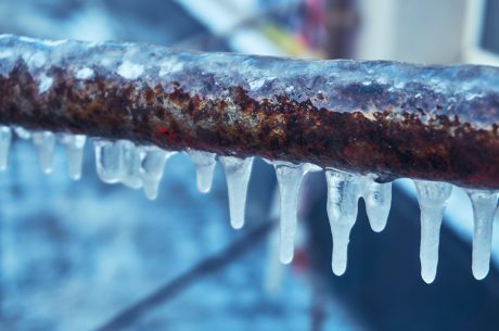 Small pipe with icicles on it.