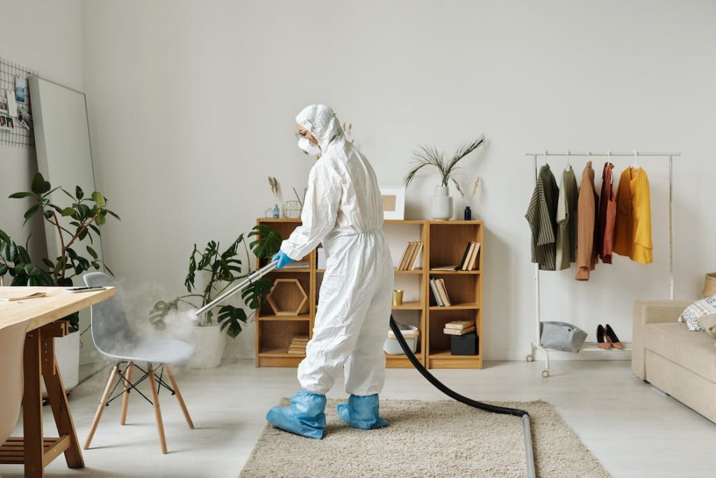 A woman fumigating while wearing a personal protective equipment