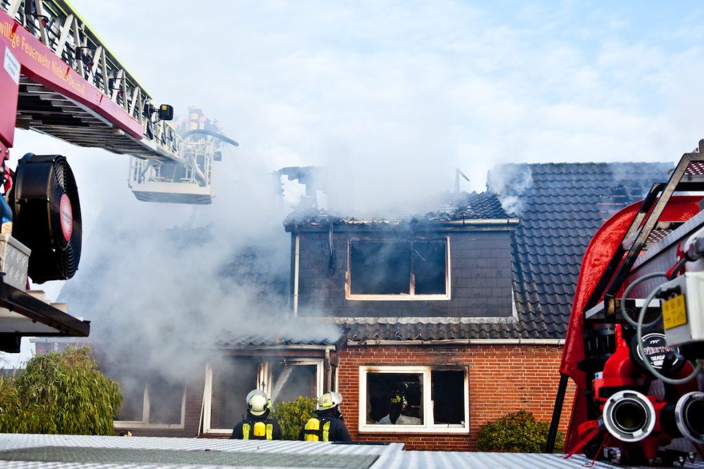 Firefighters taking care of a house fire