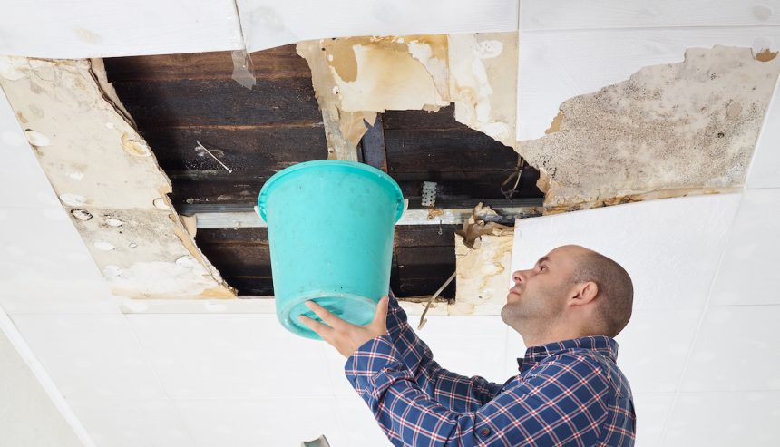 man deals with leaky roof