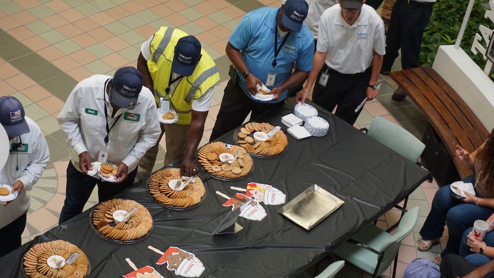 Workers from the City of Tamarac line up to indulge in some cookies offered by PuroClean on Labor Day