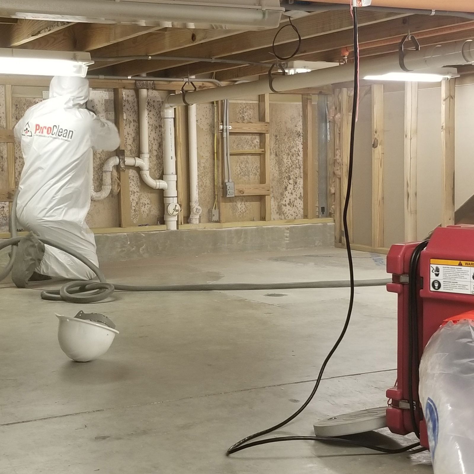 PuroClean technician cleaning a house with mold