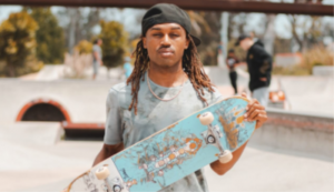 Brandon Turner of Westside Discovery is depicted holding a skateboard.