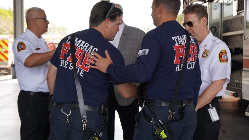 Members of the Tamarac Fire Rescue celebrate James's accomplishments.