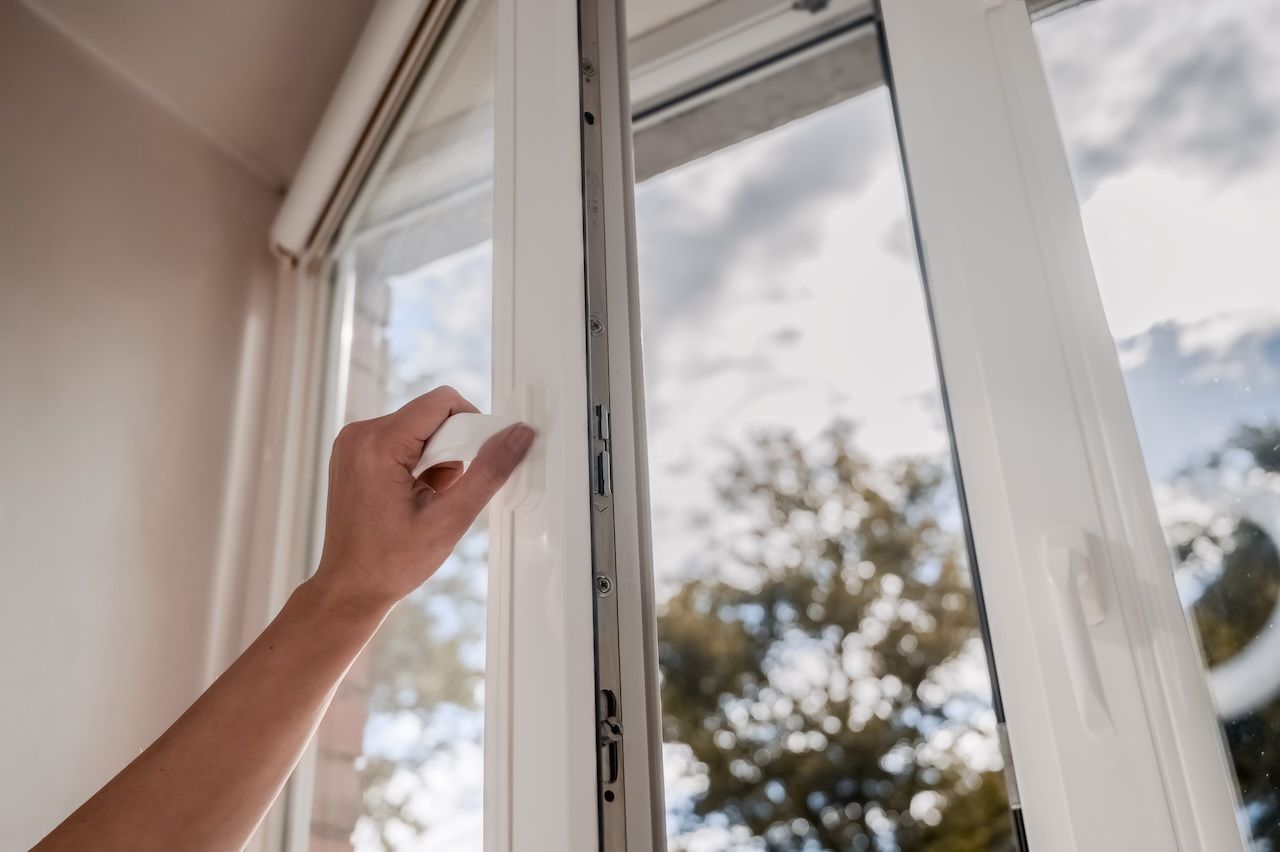 person opening a window