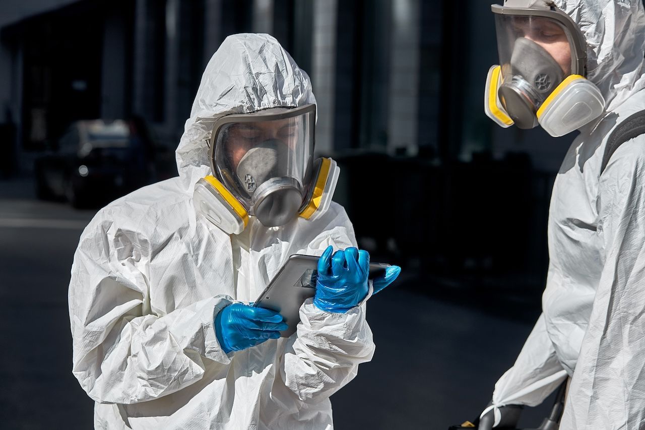 two people wearing personal protective gear