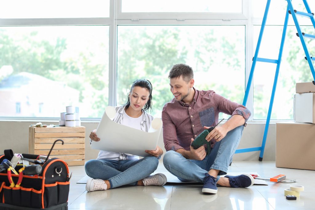 Couple doing repair in their new house after buying a water damaged house